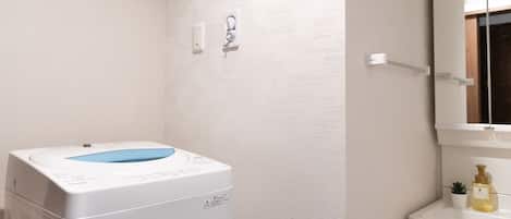 A bathroom with a white sink, a mirror, and a toilet.