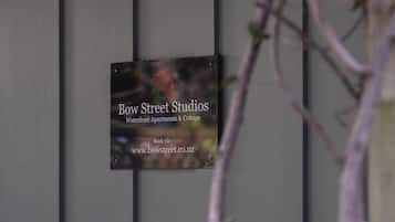 A sign for Bow Street Studios, indicating it is a waterfront apartment and cottage.