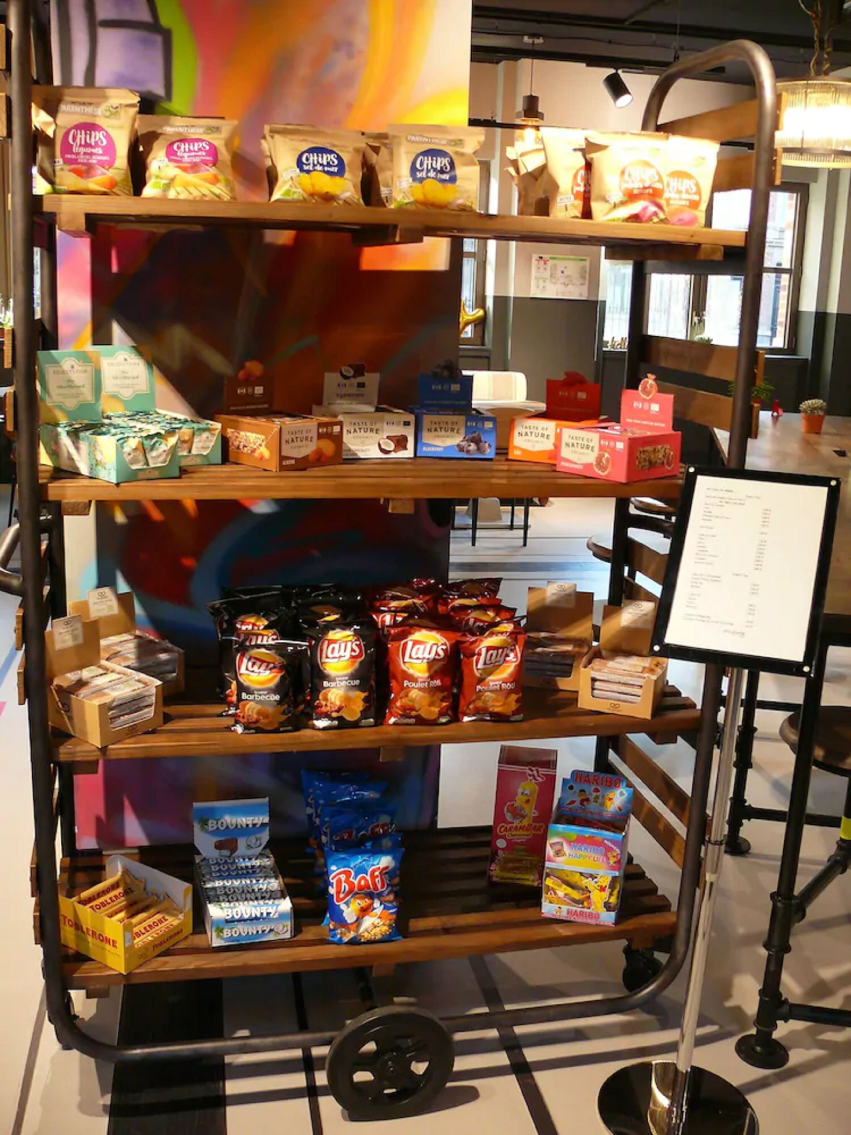 A snack display with various chips and candies.