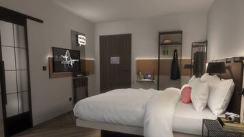 Et moderne hotelværelse med seng, fjernsyn, spejl og et lille bord med et kamera.