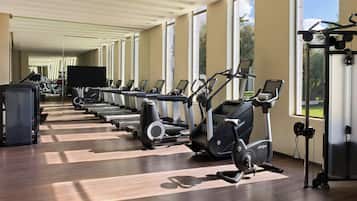A gym with treadmills, elliptical machines, and a weight machine.