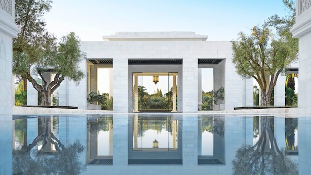 A modern building with a reflective pool, columns, and trees. - The Ritz-Carlton Rabat, Dar Es Salam (Rabat)