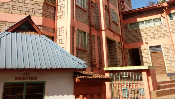 A multi-story building with a reception area at the ground level. - Salkan Hotel (Embu)