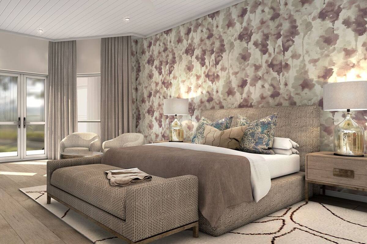 A modern bedroom with a large bed, two bedside tables, a chair, and a view of the outdoors.