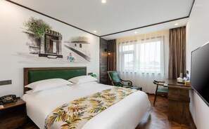 A hotel room with a large bed, a desk with a chair, a TV, and a window with curtains. - Nostalgia Hotel（Beijing Prince Gong’s Mansion） (Beijing)