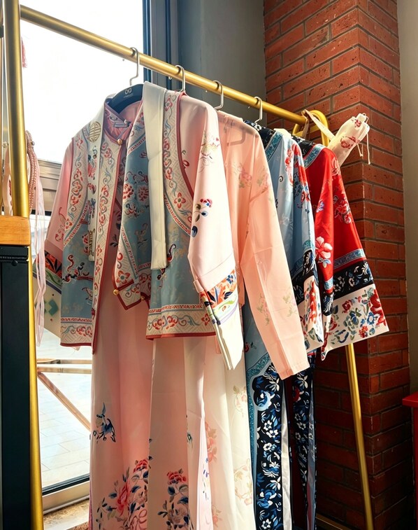 A clothing rack with various garments. - Nostalgia Hotel（Beijing Prince Gong’s Mansion） (Beijing)