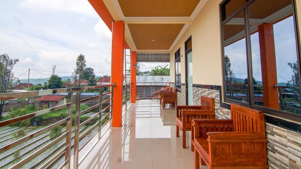 A balcony with wooden benches and a view of the surrounding area.