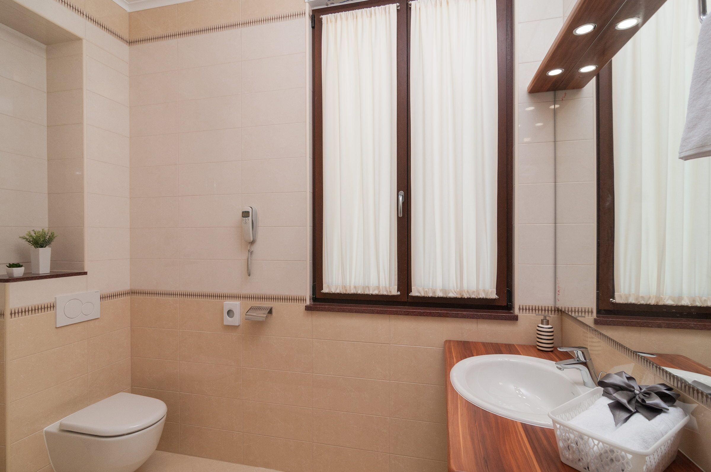 A bathroom with a toilet, sink, and shower.