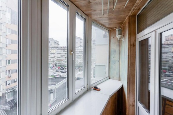 Une pièce dotée de grandes fenêtres, d’un plafond en bois et d’un banc blanc.