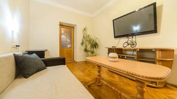 Apartamento básico, 1 quarto | Área de estar | TV de tela plana