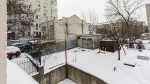 A high-rise building with multiple windows and balconies. - Cozy studio apartment near Palace Ukraina (Kyiv)
