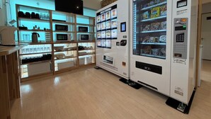 A vending machine area with microwaves and a display of food items.