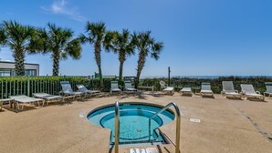 A pool area with lounge chairs and palm trees, a sign indicating a 3 ft depth, and a clear view of the ocean. - Tropical Oceanfront Spacious Condo, Outdoor Hot Tub | Emerald Cove - 7C (North Myrtle Beach)