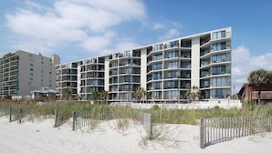 A multi-story hotel with balconies, located near a sandy beach. - Clean 6th Floor Oceanfront. Pool, Sundeck, Free Wifi | Crescent Sands WH - B6 (North Myrtle Beach)