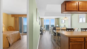 A hotel room with a balcony, a dining area, and a kitchen. - Clean 6th Floor Oceanfront. Pool, Sundeck, Free Wifi | Crescent Sands WH - B6 (North Myrtle Beach)
