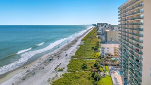 A coastal hotel with a beach view, multiple floors, and a swimming pool. - 7th Floor Windy Hill Condo. Fitness Room, Pools, Wifi | Windy Hill Dunes - 704 (North Myrtle Beach)