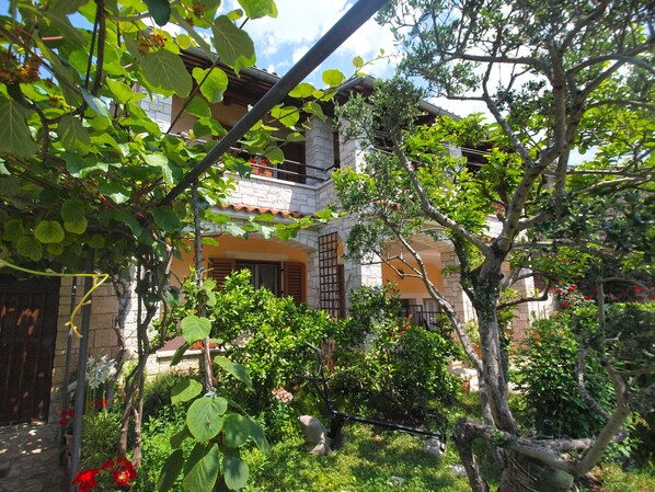 Surrounded by a lush garden, this serene retreat offers a tranquil atmosphere.