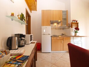 Enjoy cooking in this fully equipped kitchen with a refrigerator, microwave, and ample counter space.