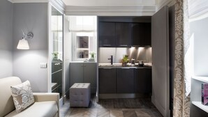 A compact kitchen with modern appliances, a built-in oven, and a window overlooking the interior.