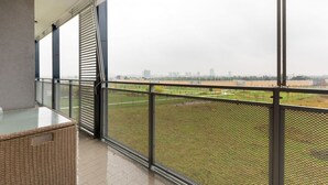 A balcony with a view of a cityscape and a green field. - GuestHost - Bright apartment included in a building of very recent construction (Milano)