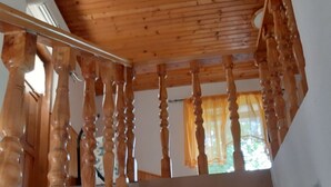 A wooden staircase with a handrail, leading to an upper floor. - Holiday House Stipe (Bakar)
