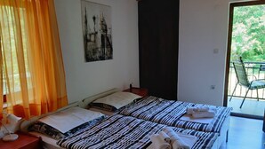 A room with two beds, a desk, and a chair. - Holiday House Stipe (Bakar)