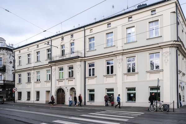 A multi-story building with a classic architectural style, featuring a series of windows and balconies.