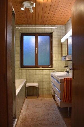Bathtub, hair dryer, towels, soap