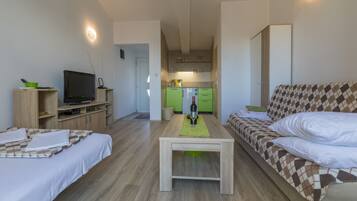 Studio, 1 Bedroom, Sea View | Living area | Flat-screen TV