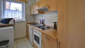 Apartment (Inselblume 42) | Private kitchen | Fridge, microwave, oven, stovetop