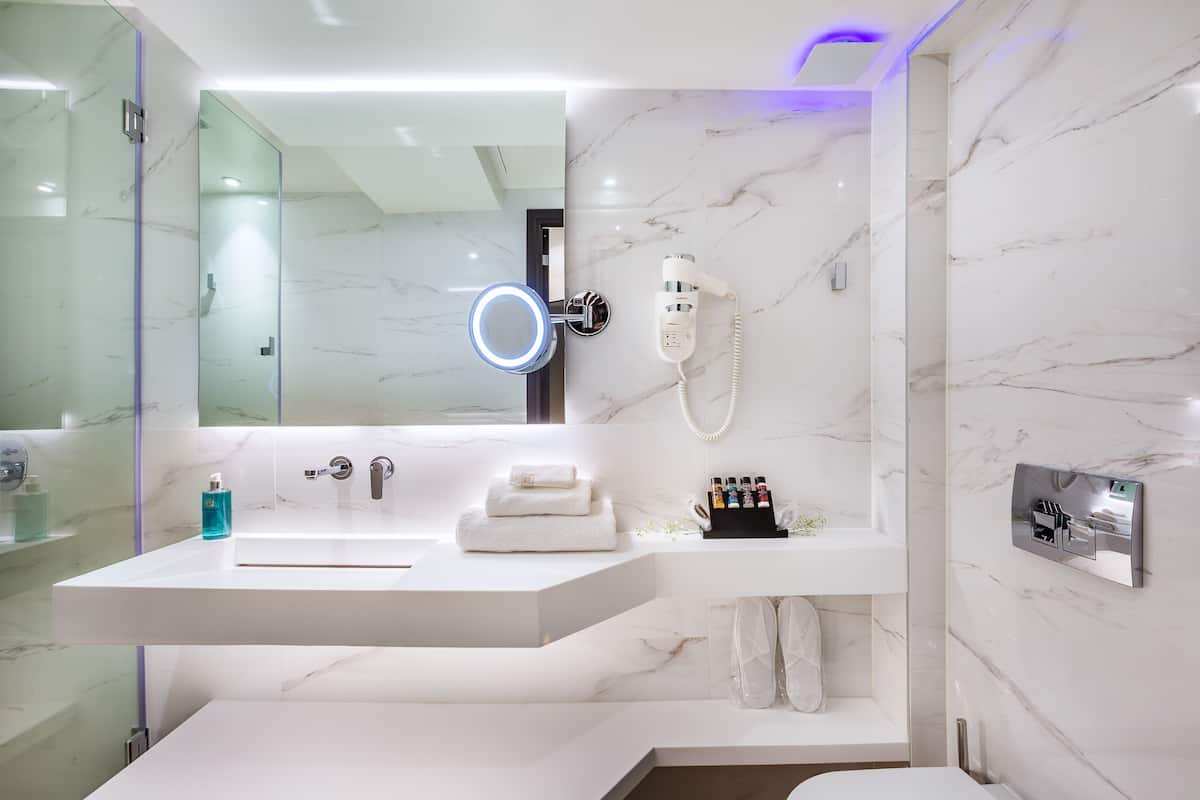 budget single backyard view | bathroom | designer toiletries, hair dryer, slippers, bidet