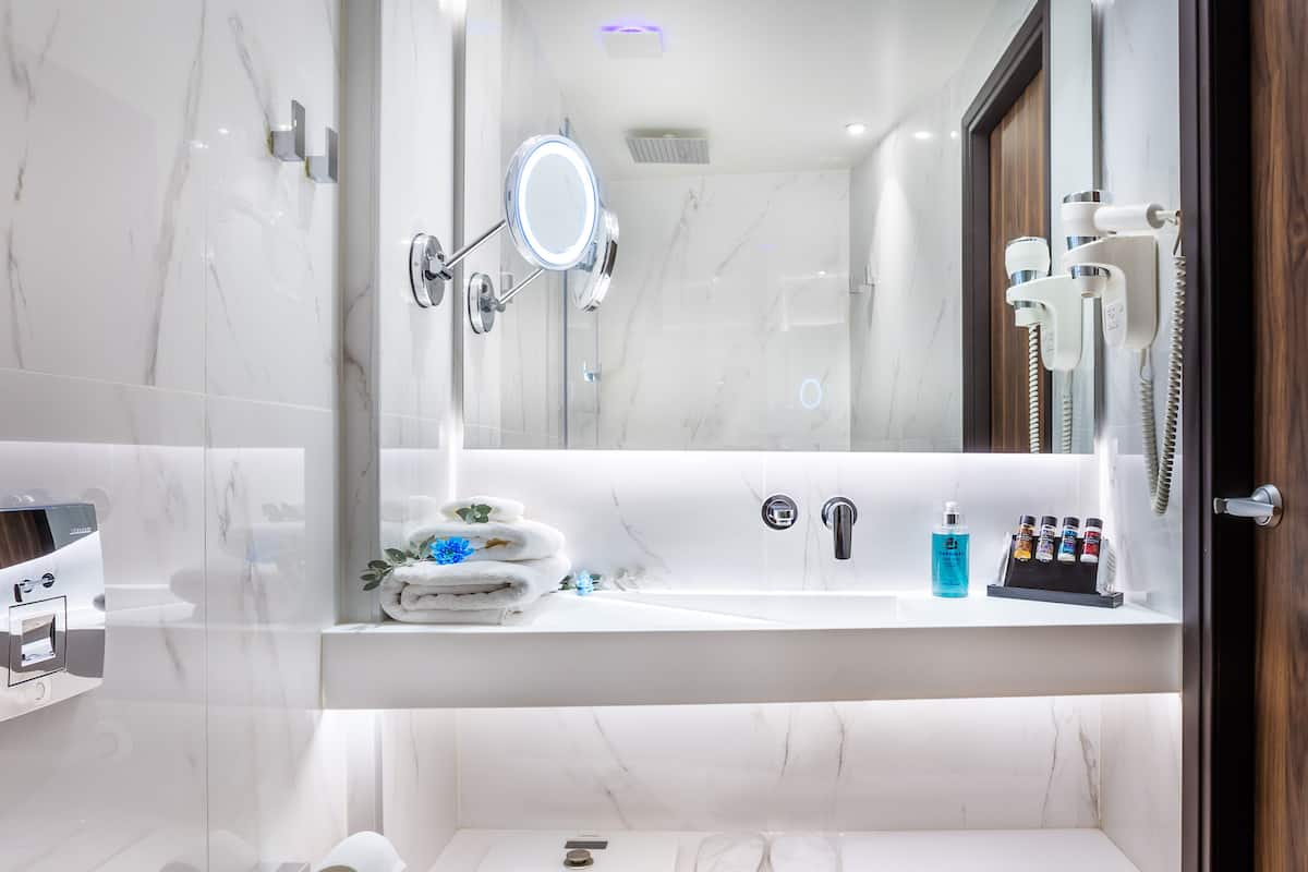 designer toiletries, hair dryer, slippers, bidet