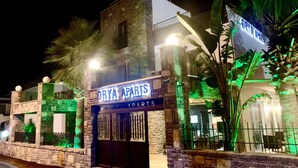 A building with a sign reading "ORYA APARTS" at night, featuring stone walls and a gated entrance. - Orya Apart (Bodrum)