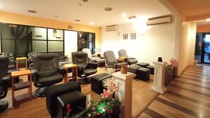 Un interior moderno con sofás de cuero, piso de madera y un amplio ventanal con cortinas.