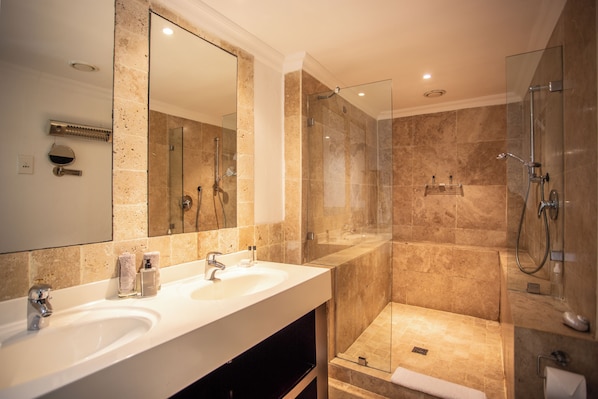 A modern bathroom with two sinks, a large mirror, and a glass-enclosed shower area. - Cape Riviera Guesthouse (Cape Town)