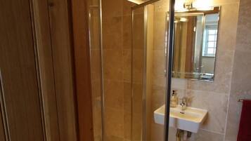 Separate bathtub and shower, rainfall showerhead, towels
