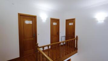 A staircase with wooden railings leading to three doors labeled 07, 08, and 09.