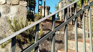 A staircase with metal railings leading up to a stone building with arched windows. - VILLA IL TORRIONE: Elegance and luxury home between Lucca and Florence with SPA (Pescia)