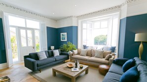 Ein geräumiges Wohnzimmer mit zwei Sofas, einem Couchtisch und einem großen Fenster für natürliches Licht.