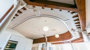 A kitchen with a built-in oven, wooden beams, and a curved ceiling. - Cribinau (Ty Croes)