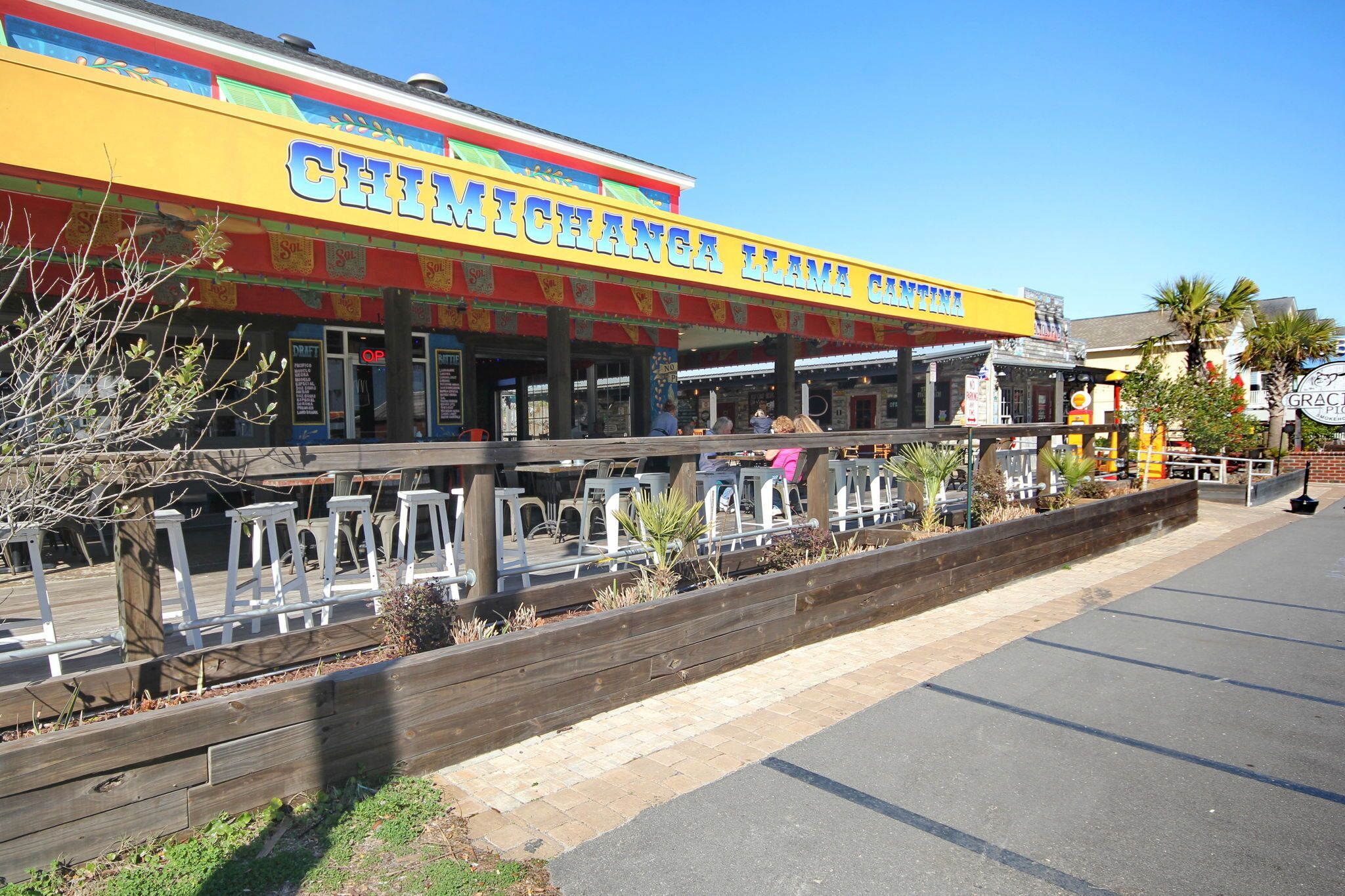 A restaurant with outdoor seating and a colorful facade.