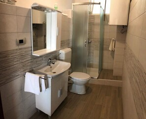 Studio | Bathroom | Shower, towels, soap, toilet paper