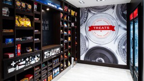 A snack display with various packaged foods and a large wall advertisement for treats.
