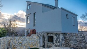 A modern two-story house with a stone facade and a chimney. - Apartment Milly (Vinodol)