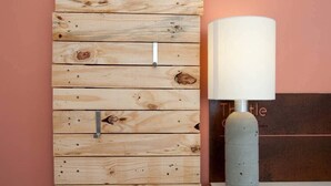 A wall with a wooden panel design and a modern lamp. - Thistledene (Braunton)