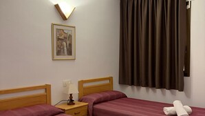 A hotel room with two beds, a nightstand with a lamp, a framed picture on the wall, and a window with curtains. - Sant Jordi Zeus Salou 33303 (Salou)