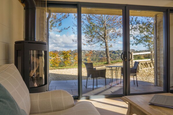 A cozy living room with a fireplace, a sofa, and a table.