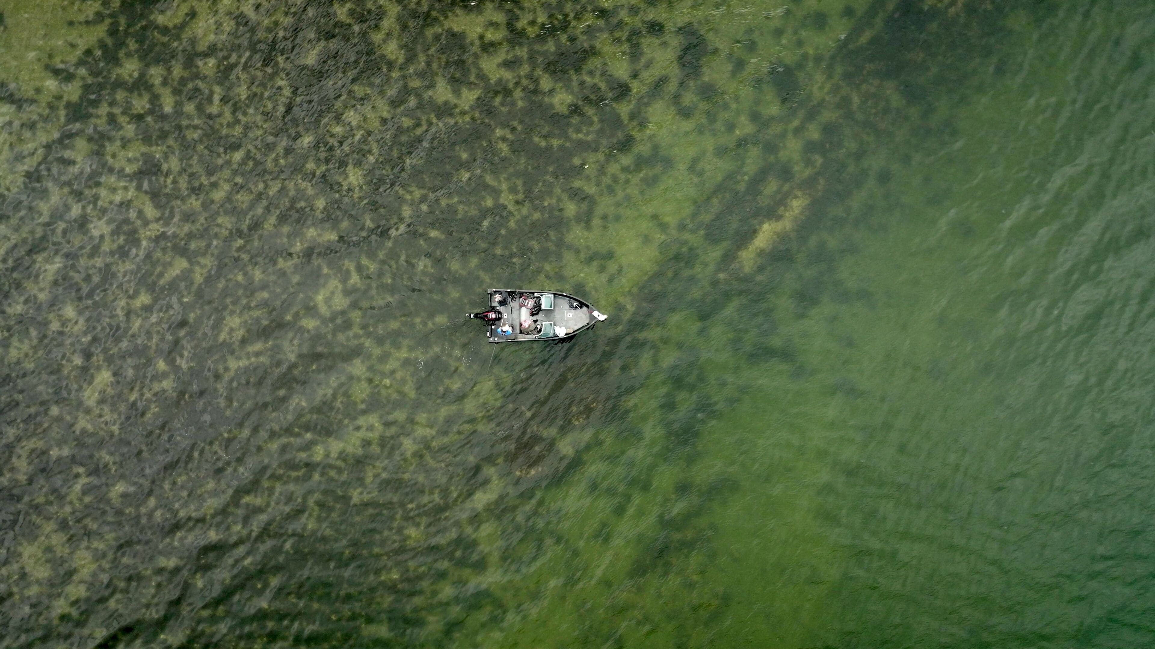 An aerial view of a boat on a body of water.