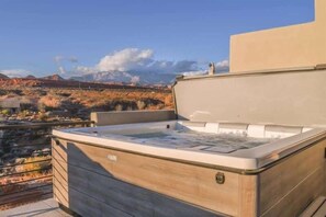 A hot tub on a rooftop with a view of a desert landscape. - Oversized Private Hot Tub with XBOX (Washington)
