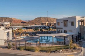 A pool area with a fenced deck, a covered seating area, and a view of a mountainous landscape. - Oversized Private Hot Tub with XBOX (Washington)